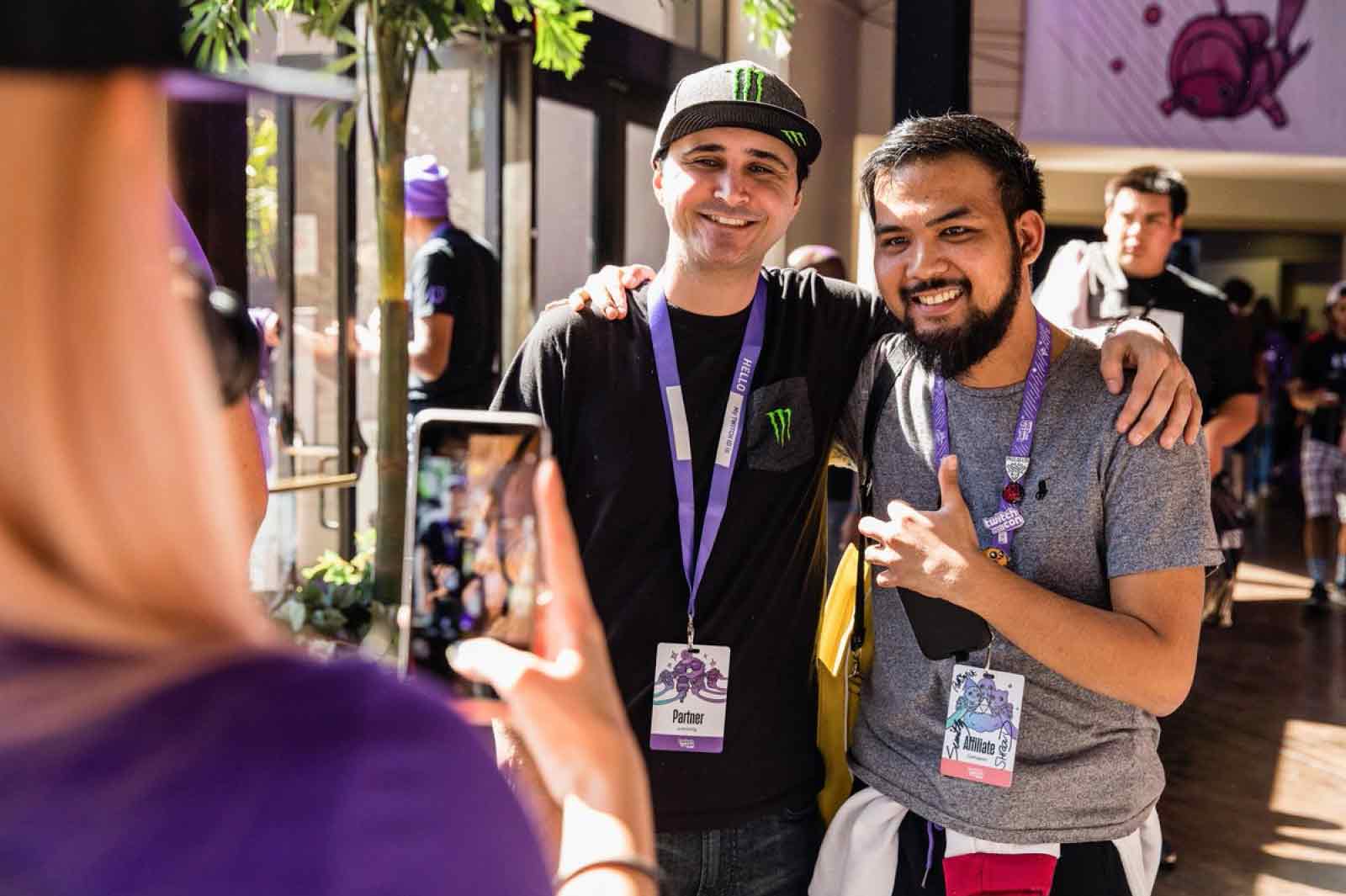 Two TwitchCon attendees pose together for a picture.