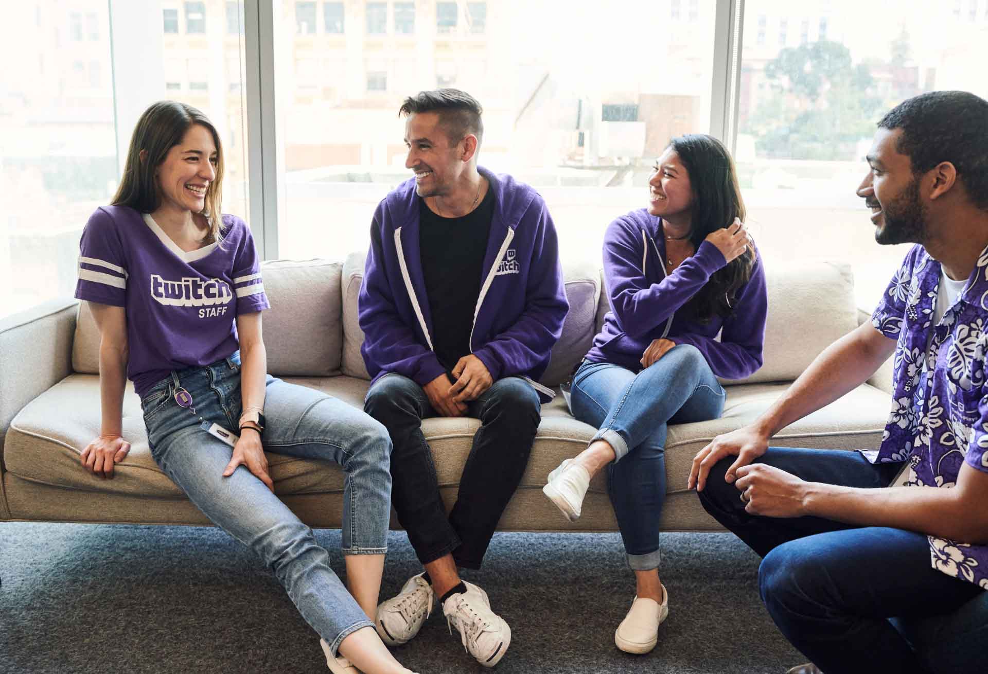 Twitch employees laughing together on a couch
